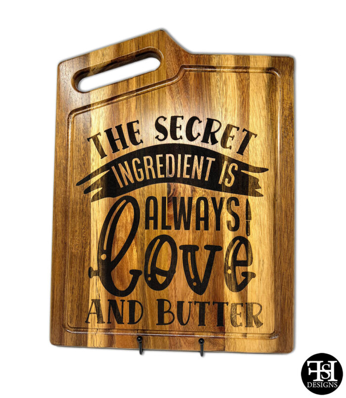 "The Secret Ingredient Is Always Love And Butter" Acacia Wood Cutting Board